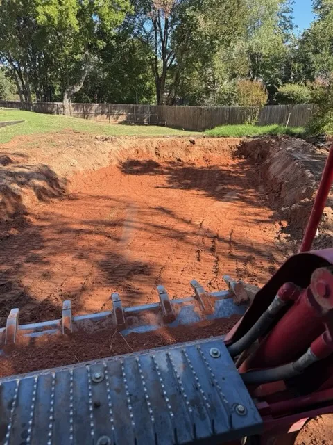 Graded red-clay lot after excavation