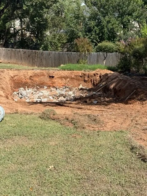 Broken concrete in the hole after a pool removal
